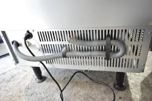 2024 Avantco 194UCF280A Undercounter Ice Machine, showing rear panel with vents, power cord, and hoses attached.