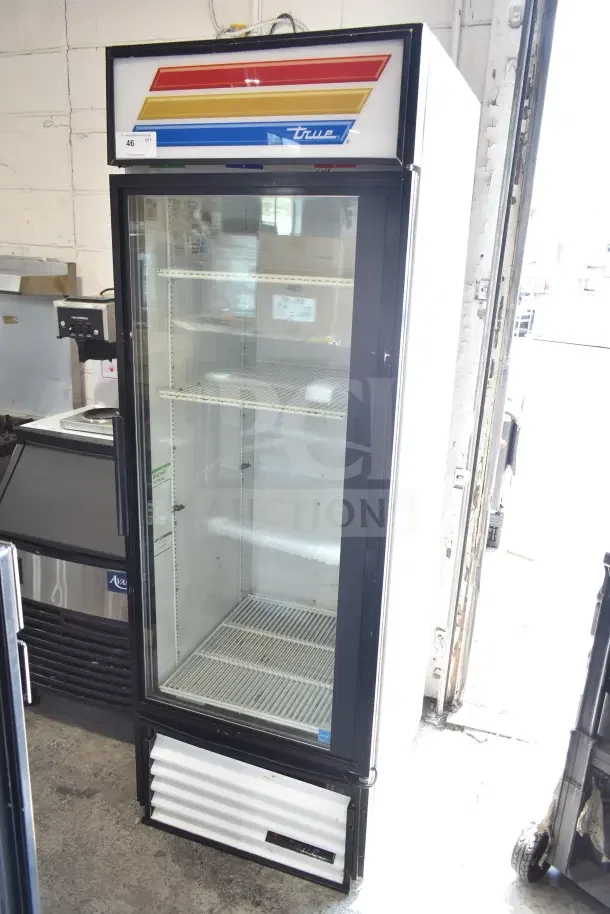 True GDM-23 commercial single door reach-in cooler merchandiser. 115 volts, 1 phase. Visible branding, clean condition.