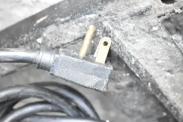 Close-up of a power plug for True GDM-23 cooler, 115 volts, 1 phase. Plug shows signs of use.