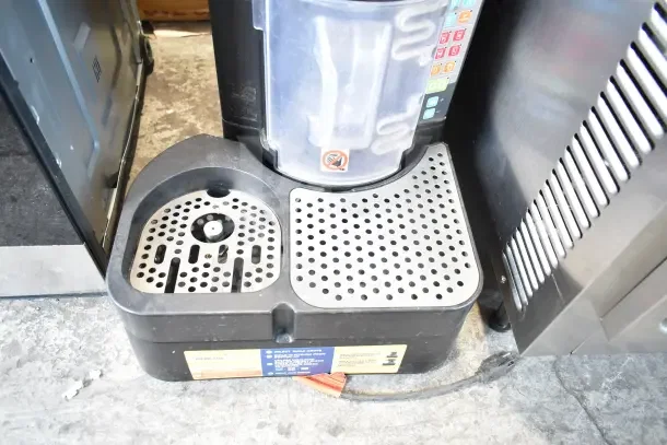 Taylor X83684-12 commercial frozen beverage machine, 115V, 1 phase, with control panel, drip tray, and signage.