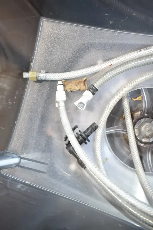 Taylor X83684-12 frozen beverage machine, visible internal components, hoses, and connections, requires cleaning.