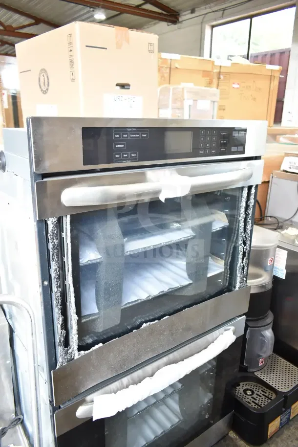 Stainless steel double stack wall mount electric convection oven, visible glass damage, control panel, and handles shown.