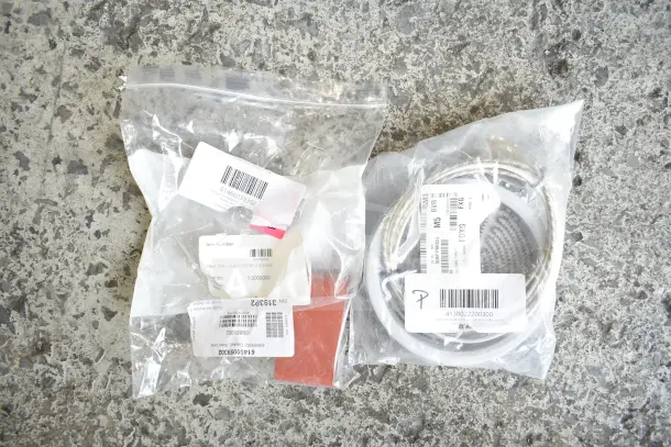 Assorted new scratch and dent items in clear packaging, labels with item numbers and barcodes visible.