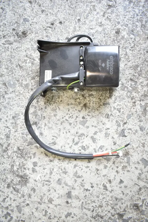 Scratch and dent Embraco electric component with wiring. Brand markings and serial label visible.