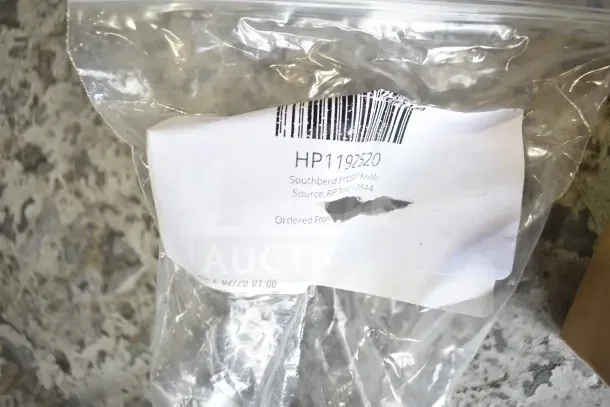 Bagged Southbend HP1192520 knob with barcode label, indicating scratch and dent condition. Part of 28-item auction lot.
