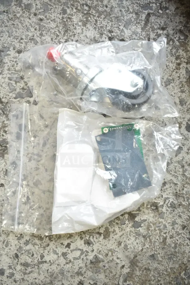 Bundle of 28 new scratch and dent items, including gasket, millivolt harness, bracket, knob, caster, in sealed plastic bags.