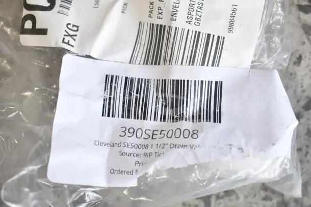 Barcode label showing "Cleveland SE50008 1 1/2" Drain Valve." Marked part of a scratch and dent auction lot.