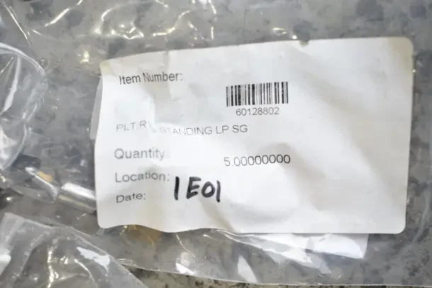 Plastic bag with item label displaying barcode 60128802, item number PLT RVS STANDING LP SG, and location 1E01.