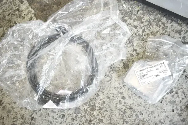 28 brand new assorted scratch and dent items in packaging, including gasket and mounting bracket. Label shows shipping details.
