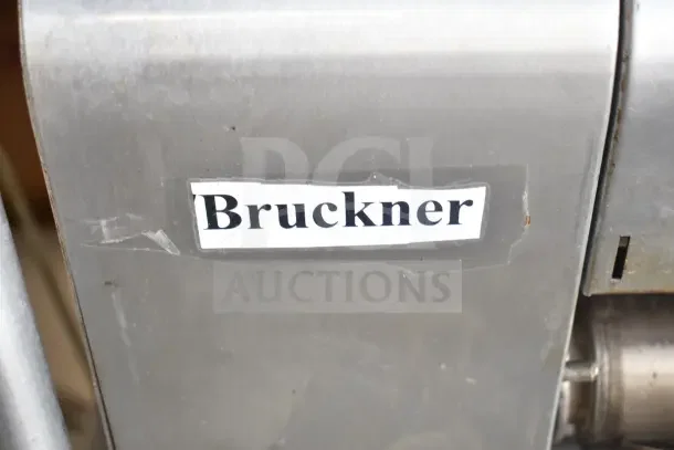 AJ Antunes GST-2H countertop bun toaster on cart. Label reads "Bruckner." 208-240V, 1 phase, robust design, commercial use.