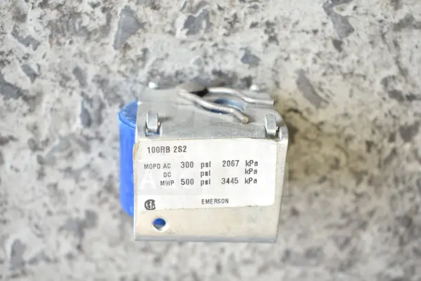 Emerson 100RB 2S2 part labeled with pressure ratings: MOPD AC 300 psi, DC 500 psi, with scratch and dent condition.