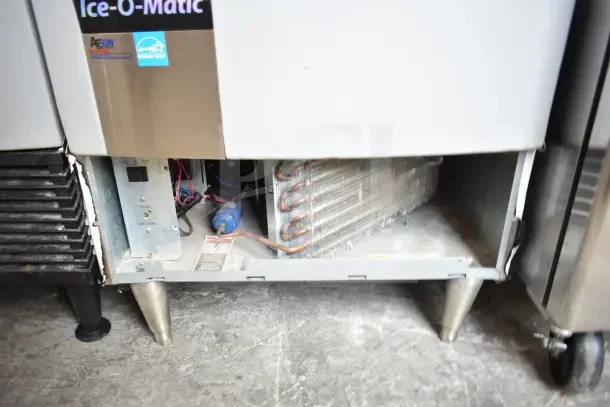 2016 Ice-O-Matic ICEU220HA3 ice machine, 115V, 1 phase, commercial use, open panel showing coils, Energy Star label.