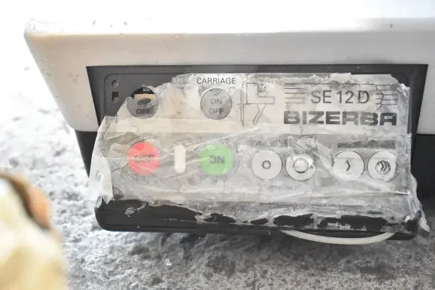Bizerba SE 12D countertop meat slicer control panel with on/off buttons, labeled with brand and model, 120 volts.