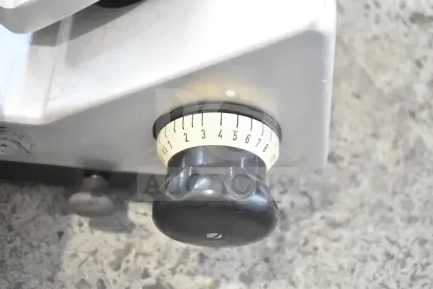 Bizerba commercial meat slicer knob with numbered dial for thickness adjustment, metal casing, 120 Volts, 1 Phase.