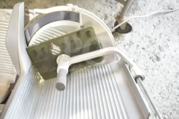 Bizerba Commercial Countertop Meat Slicer, 120 Volts, 1 Phase, shown with blade and handle, in good condition.