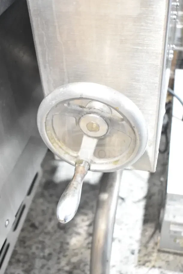 Cleveland manual tilt gas braising pan with stainless steel construction and sturdy crank handle.