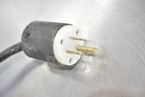Close-up of electrical plug for Cleveland braising pan, highlighting three-prong design and metal connectors.