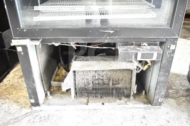 Master-Bilt IM-23GB commercial freezer with single door, visible wear on coils and interior; 115/208-230V, 1 phase power.