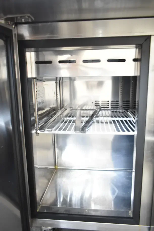 Norlake SMP36-15 commercial sandwich salad prep table interior, featuring stainless shelving and clean condition.