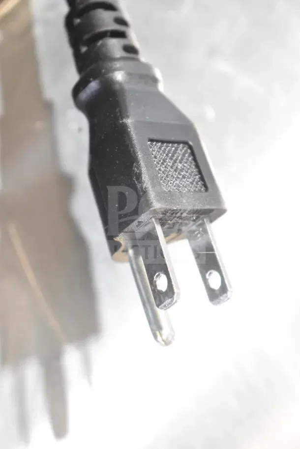 Close-up of a standard 115V power plug for the Avantco 178HBB95HC 95" bottle cooler, highlighting electrical compatibility.