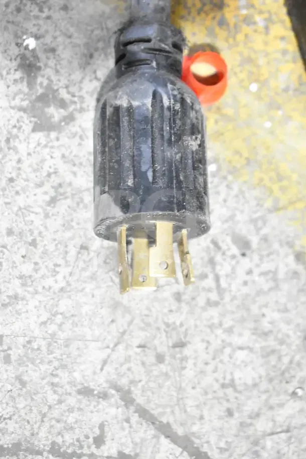 Close-up of power plug connector for 2019 Bunn IC3-DBC iced tea machine. Features visible brass prongs and black casing.