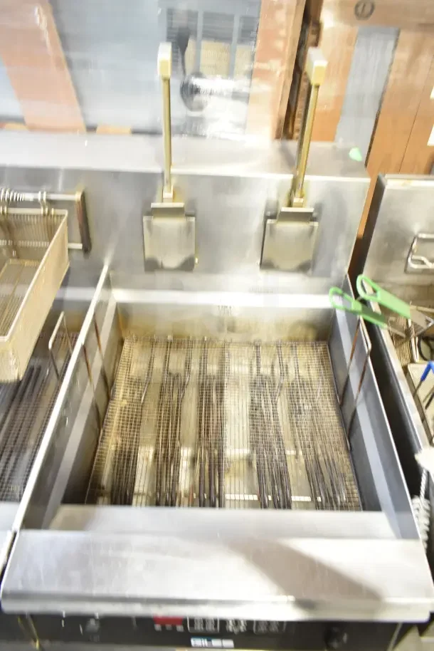 Giles EOF-24 Stainless Steel 3 Bay Fryer with dumping station, 480V, 3 Phase, on commercial casters, in fair condition.