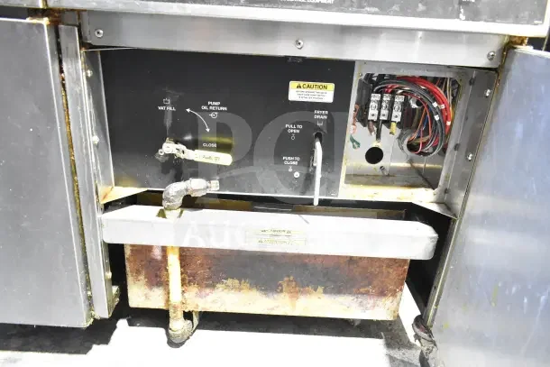 Giles EOF-24 3-bay fryer, stainless steel, electric, 480V, 3-phase, with dumping station, visible wear and labels.