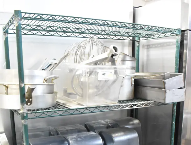 Metal shelving with mixer paddle, whisk attachments, stock pots, and skillets. Includes auction label, 25 items total.