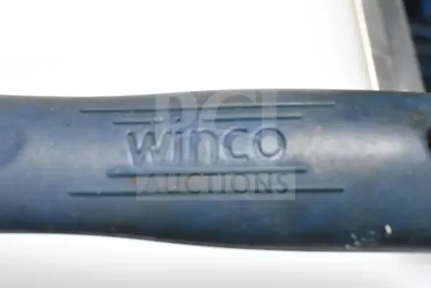 Winco handle on a kitchen utensil, indicating brand for auction of 25 varied items including mixer attachments and cookware.