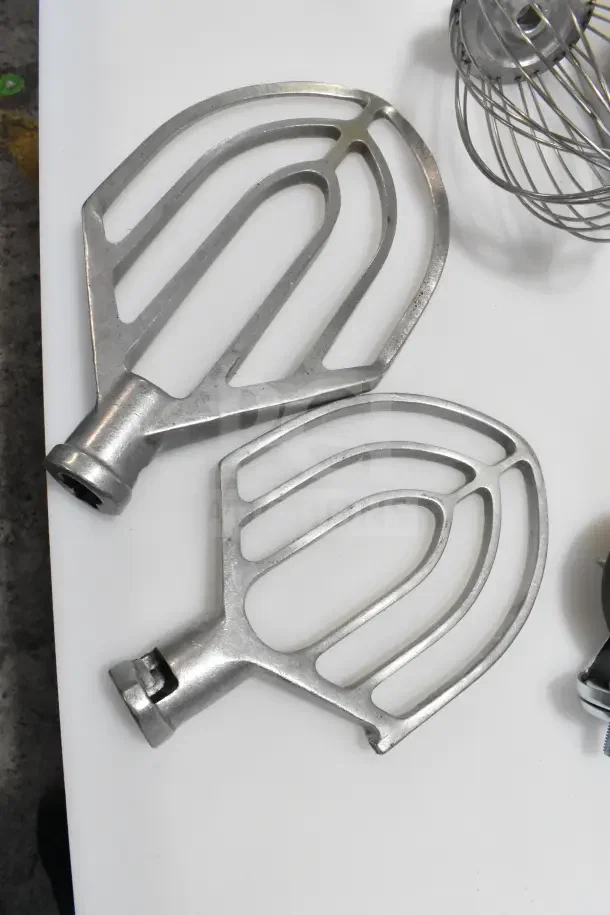 Mixer paddle and whisk attachments, metal finish, gently used. Includes additional cookware such as stock pots and skillets.
