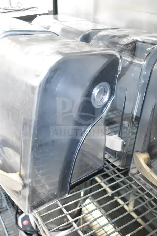 Clear sound enclosures for blenders, set of 7, showing light wear on metal shelving. Ideal for reducing noise.