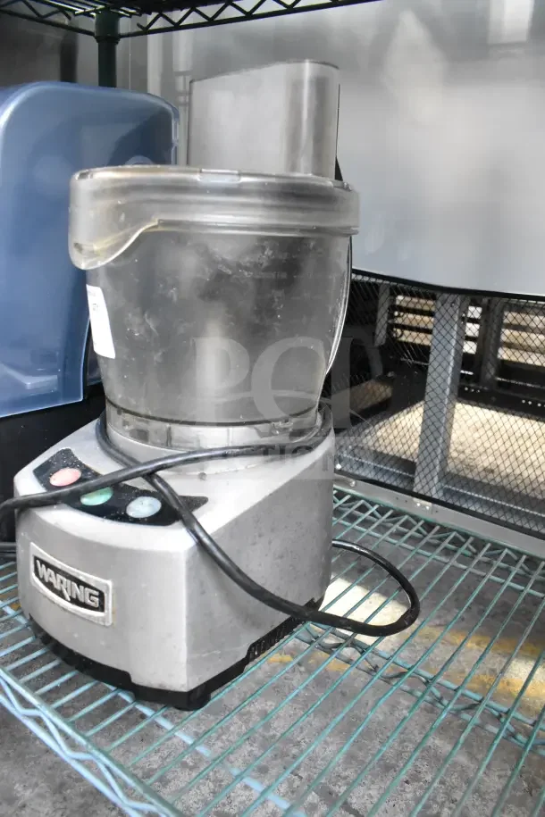 Waring countertop food processor, 120 volts, 1 phase. Features robust build, visible control buttons, and Waring branding.