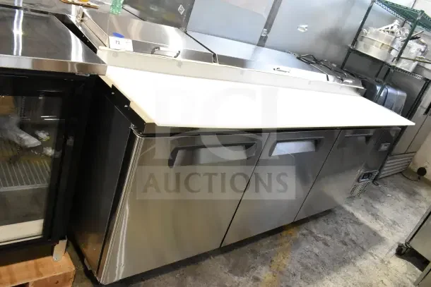 BRAND NEW Migali Commercial Pizza Prep Table, stainless steel, with minor scratches and dents, 115 Volts, 1 Phase.