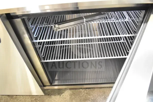 BRAND NEW SCRATCH AND DENT Migali Commercial Pizza Prep Table with metal racks, stainless finish, 115 volts, 1 phase.