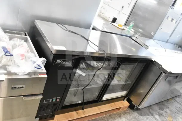 Brand new Migali C-BB60SG-HC commercial 2-door cooler, 115V, with glass doors. Some scratches and dents visible.