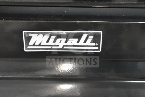 Migali logo on a black surface of the BRAND NEW SCRATCH AND DENT! 2024 C-72FM-HC Commercial 3 Door Reach In Freezer Merchandiser.