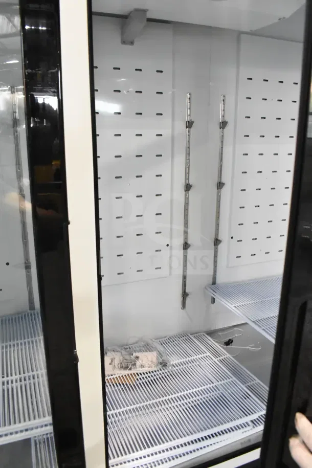 BRAND NEW Migali C-72FM-HC 3 Door Reach In Freezer Merchandiser. Visible interior shelving, pristine condition, scratch and dent.