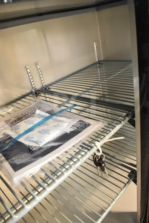 Brand new 2025 Migali C-BB48G-HC back bar cooler interior, two shelves, keys, and manual included.