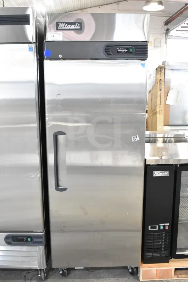 Migali commercial single door reach-in cooler, brand new with minor dents, on casters, 115 volts, 1 Phase.