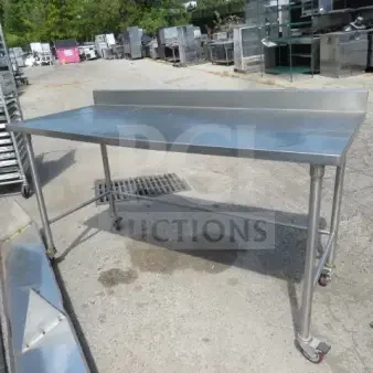 One Stainless Steel Table On Casters. 72X30X34.