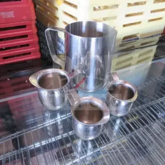 One Lot Of Frothing Pitcher And 3 SS Creamers.
